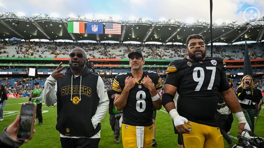 Mike Tomlin, Aaron Rodgers, and Cameron Heyward walk off the field at Croke Park in Dublin, Ireland following Pittsburgh's 24-21 win over the Minnesota Vikings.