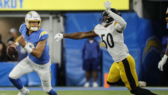 Chargers quarterback Justin Herbert, left, eludes Steelers linebacker Delontae Scott. Chargers quarterback Justin Herbert, left, eludes Steelers linebacker Delontae Scott.