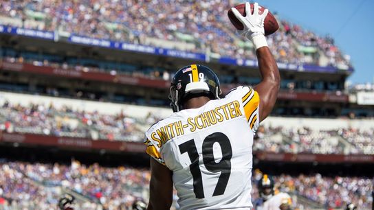 Former Steelers' WR Juju Smith-Schuster holds up the football while celebrating scoring a touchdown on the road. Steelers' JuJu Smith-Schuster