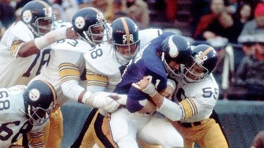 Jack Ham (59) and Jack Lambert (58) haul down Vikings fullback Dave Osborn (41) with other Steelers in support during Pittsburgh's 16-6 win in Super Bowl IX.